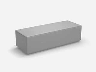 Technical 3D drawing of a narrow, rectangular modular element in neutral gray that serves as a bench.