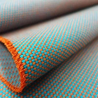 Novum fabric sample, featuring a pattern in turquoise and orange.