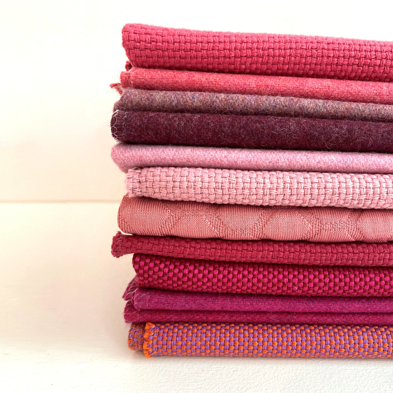 Pile of pink fabrics